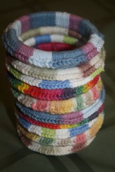 a stack of multicolored crochet bracelets sitting on top of each other