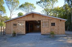 an open garage with two doors and windows