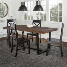 a dining room table with two chairs next to it