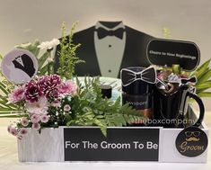 the groom's gift box is filled with flowers and personal items for his groom