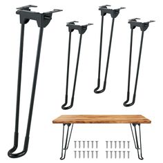 four pairs of black iron and wood bench legs with hooks on each side, one is holding