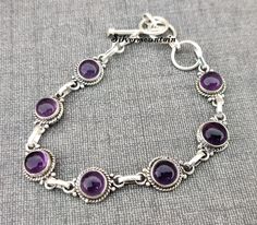 Amethyst Gemstone Bracelet, Round Shape Bracelet, 925 Sterling Silver Bracelet, lovely Bracelet, Designer Bracelet, Handmade Bracelet, ---------------------------------------------------------------------------------------------------------------------------------------------------- Description Metal :- 925 Sterling Silver Style : Bracelet Benefits Of Amethyst Amethyst Provides Serenity. Amethyst Promotes Hormone Balance. Amethyst Can Help With Weight Loss. Amethyst Detoxifies the Body. Amethyst Sterling Silver Amethyst Bracelet With Gemstone, Adjustable Silver Chain Bracelet, Purple Sterling Silver Bracelet With Gemstone, Purple Sterling Silver Gemstone Bracelet, Adjustable Amethyst Sterling Silver Bracelet, Purple Sterling Silver Round Bracelets, Handmade Amethyst Sterling Silver Bracelet, Handmade Sterling Silver Amethyst Bracelet, Purple Sterling Silver Round Bracelet