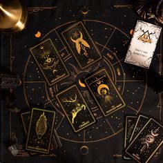 the taroti card game is set up on a table with gold foil and other items