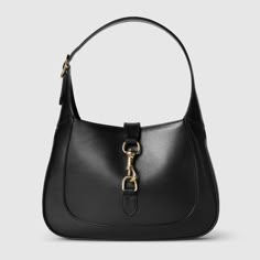 "Find GUCCI Jackie Small Shoulder Bag on Editorialist. The Gucci Jackie shoulder bag is crafted from premium fine leather. The bag features a crescent shape, a sleek silhouette, and a light gold-toned hook closure. The bag includes a leather trim and a Web strap for additional styling options. The interior of the bag has one zip pocket with a Gucci Crest zip puller. The bag has a 7.1\" handle drop and a detachable Web shoulder strap with a 20.5\" drop. The bag is 10.8\"W x 7.5\"H x 1.6\"D and we