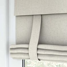 a close up view of the roman blind in an open window