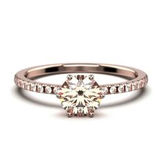 a rose gold engagement ring with diamonds on the band and a round cut diamond in the center