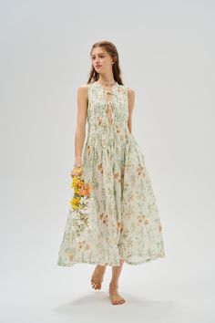 Wear this enchanting dress and stroll through a dreamy garden of fluttering butterflies and blooming flowers~. It is a masterpiece of romantic design. Delicate pleats add a touch of elegance and movement to the piece, creating a magical feel. The lace ruffle detail adds an extra sweet touch to the overall look. The colourful orange flowers and green leaves in a chic patchwork effect sway with your steps, bringing a warm and vibrant charm to the dress, perfect for a garden party. 【Fabric】 100% li Botanical Dress, Fairycore Dress, Enchanting Dress, Dreamy Garden, Fluttering Butterflies, Dress Cottagecore, Shirred Dress, Cottagecore Dress, Romantic Design