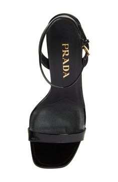 A sculptural heel with an iconic Prada triangular logo supports this minimalist ankle-strap sandal crafted of glossy calfskin leather. 3 1/2" (89mm) heel Adjustable ankle strap with buckle closure Leather upper, lining and sole Made in Italy Designer Shoes Sleek Formal Sandals With Glossy Finish, Glossy Ankle Strap Sandals For Evening, Glossy Finish Ankle Strap Sandals For Evening, Luxury Leather Sandals With Glossy Finish, Designer Leather Sandals With Glossy Finish, Modern Sandals With Glossy Finish And Open Heel, Sleek Patent Leather Sandals With 4-inch Heel, Luxury Heels With Glossy Finish And Open Heel, Luxury Glossy Open Heel Heels