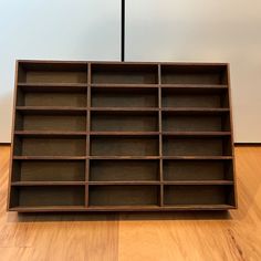 a wooden shelf sitting on top of a hard wood floor