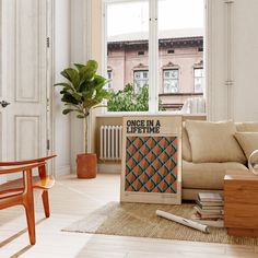 a living room filled with furniture and a large poster on the wall above it that says, one in a life time