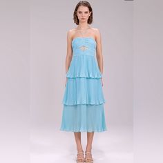 This Dress Is An Absolute Stunner. Material Is Light & Airy, And The Overall Look Is Flawless And Beautiful. The Closest Thing To Being On A Seaside Holiday Without Turning On Your Ooo, This Dress Is Made From Airy Chiffon In A Refreshing Shade Of Turquoise. Its Fitted And Pleated Bodice Is Accented By A Halterneck And Cut-Out, While The Skirt's Sheer Third Tier Will Subtly Show Off Your Legs. Wear It To A Garden Party, Wedding, Or A Beach Bar, If You Should Be So Lucky. Purchased Two Sizes! The Summer Evening Tiered Chiffon Dress, Tiered Chiffon Evening Dress For Summer, Elegant Light Blue Tiered Maxi Dress, Blue Tiered Dress For Gala, Pleated Chiffon Cocktail Dress For Summer, Summer Pleated Chiffon Cocktail Dress, Blue Midi Length Pleated Dress For Evening, Light Blue Tiered Party Dress, Spring Party Chiffon Dress With Pleated Bodice