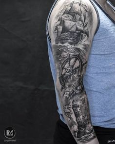 a man's arm with a ship and compass tattoo on it