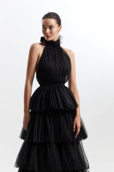 Black Halter Neck Tie Up frilled Evening Dress The Black Halter Neck Tie Up frilled Evening Dress This stunning dress features a halter neckline and a beautiful open back adorned with intricate lace detailing making it a perfect choice for an evening party. Tiered Ruffled Skirt Evening Dress, Tiered Ruffled Evening Dress, Sleeveless Ruffled Skirt Evening Dress For Gala, Black Sleeveless Halter Dress For Wedding, Black Sleeveless Halter Wedding Dress, Backless Party Dress With Ruffled Skirt, Backless Ruffled Dresses For Evening, Backless Dress With Ruffled Skirt For Party, Elegant Tiered Ruffle Dress For Gala