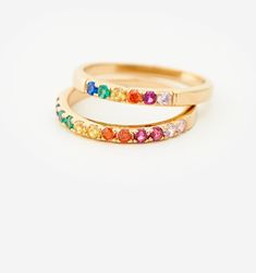 Meet our Mini Rainbow Band Ring- this whimsical piece is adorned with an arc of meticulously selected CZ stones, each shimmering with the joyous hues of the rainbow. Perfect for the color-loving daydreamer, this ring is more than an accessory—it's your very own piece of wearable joy. Adjustable Rainbow Stackable Jewelry, Adjustable Rainbow Gemstone Ring, Elegant Adjustable Rainbow Rings, Adjustable Rainbow Birthstone Jewelry, Adjustable Multi-stone Rainbow Jewelry, Rainbow Multi-stone Birthstone Ring For Anniversary, Rainbow Cubic Zirconia Jewelry With Sparkling Stones, Rainbow Cubic Zirconia Jewelry For Wedding, Rainbow Cubic Zirconia Wedding Jewelry