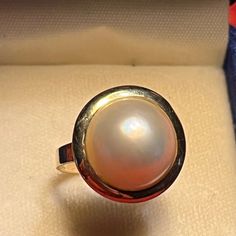 This 16mm Diameter Mabe Pearl Ring Is Set In A 14kt Yellow Gold Back Caged And Smooth Top Bezel Mounting. No Prongs To Snag, Yet Mounted Without Glue Or Drilling Holes. It Is Classic Beauty At Its Best. And When Combined With The Matching Pendant (See Photos), It Is A Beautiful Set Of Timeless Elegance And Design! Note: The Matching 19mm Diameter Mabe Pearl And 14kt Yellow Gold Pendant (See Last Photo) Is Available And Sold Separately. In Excellent Condition From A Pampered Jewelry Box. All Reasonable Offers Considered. Bundle With Other Items For Savings. Message Me With Questions. Fast Shipping. Thank You For Stopping By My Closet! Fine Jewelry | H Pearl Bridal Jewelry, Heirlooms Jewelry, Mabe Pearl, Drilling Holes, Yellow Gold Pendants, Yellow Gold Ring, Classic Beauty, Pearl Ring, 14kt Gold