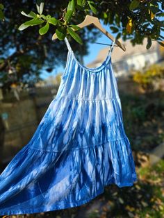 Indigo Hand-Dyed Dress- One a Kind This spaghetti strap dress was hand dyed in indigo dye after being hand sewn with the unique design.  I hand dyed this line of dresses through Shibori, a Japanese dyeing technique that includes bundling, binding and/or folding the fabric with a resist. The results are a wonderful surprise with organic and geometric patterns. Shibori techniques have been used for thousands of years but I recently learned and fell in love with it myself. These works of art are perfect for any time of the year. Warm it up with a light jacket for those summer nights we all love so much. Dress it up with some cowgirl boots. Add your favorite leggings and a cute sweater cardigan for the cold weather season. Just saying ; ) Old Navy 96% Cotton 4% Spandex Sizes available: 1- Smal Casual Tie Dye Dress With Spaghetti Straps, Summer Tie-dye Dress With Natural Dye, Summer Tie Dye Dresses With Natural Dye, Summer Tie Dye Dress With Natural Dye, Blue Summer Dress With Natural Dye, Blue Vacation Dress With Natural Dye, Blue Vacation Dresses With Natural Dye, Blue Dresses With Natural Dye For Vacation, Hand Dyed Cotton Beach Dress