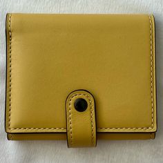 Excellent Used Condition. Glovetanned Leather Six Credit Card Slots Full-Length Bill Compartment Zip Coin Pocket Snap Closure 4 1/4" (L) X 3 1/4" (H) Elegant Yellow Leather Wallet, Leather Trifold Wallet With Magnetic Closure For Travel, Classic Leather Wallet With Magnetic Closure, Classic Coach Leather Wallets, Tan Leather Wallet, Rectangular, Tan Leather Rectangular Wallet, Tan Leather Wallet With Interior Card Slots, Coach Leather Trifold Wallet For Everyday Use, Rectangular Leather Wallet With Snap Closure