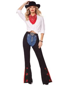 a woman in a white shirt and black jeans with red roses on the side is wearing a cowboy hat