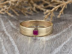 Mens Ruby Wedding Band, Princess Cut Ruby Mens Wedding Band, Solid Gold 10k/14k/18k Wedding Ring, His Wedding Band by Sapheena A classic men's wedding band that set with a single brilliant princess cut Red Ruby made in solid 14k/18k yellow gold. Also available in rose, white or yellow gold. You can choose your finish to be shiny or matte. ** Ring Description: * Metal: solid 14k/18k rose, white or yellow gold * Princess cut red ruby * Total carat weight approx. 0.18ct * Ring width: front approx. Luxury Polished Finish Men's Ruby Ring, Wedding Rings Ruby Men, Luxury Ruby Men's Ring As Gift, Gold Ruby Wedding Ring 14k, Yellow Gold Hallmarked Ruby Ring For Wedding, Heirloom Gold Ruby Ring For Wedding, Hallmarked Yellow Gold Ruby Ring For Wedding, Gold Ruby Princess Cut Ring For Wedding, Ruby Wedding Ring With Diamond Cut