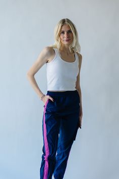 We couldn’t keep something this good to ourselves. These jogger style windbreaker pants our exclusive to us + come in inclusive sizing. They have a thick + flexible waistband with pink stripe down the sides of the legs. Pair with The Dua Windbreaker to make it a set. Details Model is wearing a small self/lining: 100% cotton Fabric Care Guide Here Sizing & Fit Measurements are approximate and taken while laying flat across the front. Not doubled. x-small: waist = 12"; length = 38"; inseam = 27" s Casual Spring Joggers With Side Stripes, Spring Joggers With Side Stripes For Jogging, Sporty Sweatpants With Side Stripes For Spring, Trendy Joggers With Elastic Side Panels For Spring, Trendy Spring Joggers With Elastic Side Panels, Athleisure Three Stripes Joggers For Spring, Pink Sporty Parachute Pants For Spring, Athleisure Joggers With Three Stripes For Spring, Spring Sweatpants With Side Stripes For Jogging