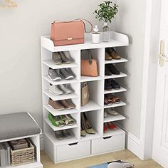 a white shoe rack with shoes and purses on it next to a door way