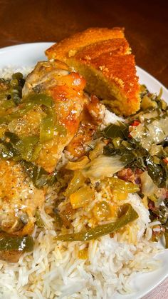 a white plate topped with rice and meat covered in green peppers next to a slice of bread