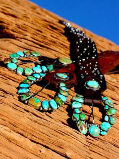 "On the Range" turquoise ranger buckles, what a statement! These buckle are inspired, artful creations and look amazing with any belt combination, especially the "Wild West" turquoise conchos. They are a fine combination of several American mines, including Royston, Piolet, Kingman and Sonoran gold. "On the Range" our horseshoe ranger shape is about 4 by 4 inches of the best turquoise money can buy.. Size and quality of stones can vary so pricing these is very challenging, so please contact us f Southwestern Turquoise Concho Belt Buckles, Western Turquoise Belt With Concho, Turquoise Western Belt With Concho, Adjustable Turquoise Western Belt Buckles, Turquoise Bohemian Belt With Concho, Turquoise Bohemian Belt Buckle With Antique Detail, Saddle Shop, Turquoise Belt, 4 By 4