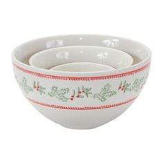 three white bowls with holly designs and red trimmings on the bottom, one bowl has