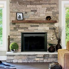 A floating mantel installed on a floor to ceiling limestone and granite fireplace Wall Interior Design Ideas, Stone Wall Interior, Stone Wall Interior Design, Floating Fireplace Mantel, Modern Fireplace Mantels, Rustic Mantle, Farmhouse Mantel, Floating Fireplace, Rustic Fireplace Mantels