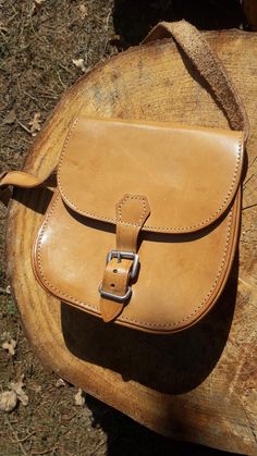 Small Beige Leather Bag, crafted from 100% leather, boasts a light brown color and simple form. 100% Leather Compact Size Unlined Natural Interior: Interior 1 large compartment, unlined, natural raw leather interior. Dimensions Height: 6 1/2" / 17 cm Width: 6 1/2" / 17 cm Depth: 2" / 4,5 cm Strap: adjustable, max 110 cm / 43" Condition The bag is in nice vintage condition with one mentionable flaw: pictured on the last photo - there is a white color flaw at the beginning of the strap. Classic Brown Pouch Saddle Bag, Classic Brown Saddle Bag Pouch, Classic Brown Vegetable Tanned Leather Saddle Bag, Brown Vegetable-tanned Saddle Bag For Everyday Use, Classic Beige Satchel As Gift, Classic Natural Satchel Shoulder Bag, Brown Leather Saddle Bag With Vegetable-tanned Details, Brown Vegetable-tanned Leather Saddle Bag, Classic Saddle Bag With Leather Strap For Daily Use