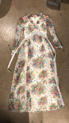 "Probably one of the best examples of a 70's prairie dress I've seen, purely based on the floral print alone! I just love the colors. Attached lace sash (linger on one side than the other) and multi-layer skirt. Fully lined. Does need a soak/dry clean as it has been in storage for decades. Reflected in price. Bust: 32\" Waist: 24\" Hips: free Length: 56\" Model is 5'7\" and 115 lbs with measurements of 32x24x34. Buy with confidence as all photos are taken in natural lighting." Vintage Multicolor Maxi Dress For Garden Party, Vintage Spring Maxi Dress With Vintage Print, Spring Floral Print Fitted Prairie Dress, Spring Vintage Maxi Dress With Vintage Print, Flowy Vintage Multicolor Dresses, Vintage Maxi Dress For Spring, Flowy Multicolor Vintage Dresses, Spring Vintage Maxi Dress, Vintage Floral Print Prairie Dress For Garden Party