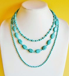 This is a very eye catching piece that you can use to dress up or down. The turquoise color is very popular and eye catching as well. I crafted the whole necklace with genuine Turquoise and Magnesite gemstone beads in different shapes and sizes. It is made of three strands, where the shortest strand is about 16 inches long while the longest strand is about 23 inches long. A lobster  heart clasp finishes off the necklace with a 3 inch long extender. TIP: I enjoy wearing my necklace with silver ch Turquoise Multi-strand Gemstone Necklaces, Turquoise Multi-strand Gemstone Necklace, Turquoise Gemstone Multi-strand Necklace, Double Strand Turquoise Necklace For Gift, Multi-strand Turquoise Necklace For Gifts, Turquoise Multi-strand Necklace For Gift, Natural Stone Jewelry, Beaded Statement Necklace, Chain Necklaces