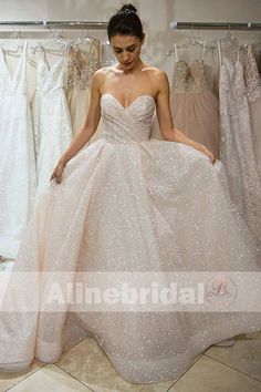 a woman standing in front of some dresses