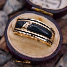 This gorgeous designer ring is by John Tolle out of Laguna Beach, CA features domed onyx inlays with antiqued channels on each side of the onyx. The ring is crafted in 14k yellow gold and is a size 9. We are not offering resizing due to the onyx inlay. Mens Onyx Wedding Ring, Onyx And Diamond Ring Men, Onyx Wedding Band, Onyx Wedding Ring, Laguna Beach, Mens Wedding Bands, Ring Designs, Onyx, Wedding Bands