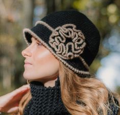 "1920s Winter Woman Hat with the flower in retro style. This is a beautiful warm cloche hat in black with a brim and a big flower. It is made from %40 wool and 60 acrylic soft yarn. It is ready to ship! You can use the hat as a beautiful accessory or just to keep yourself warm on cold winter days. Fits a head circumference of 22\"(57 cm).  How To Measure For A Hat? To measure your head circumference, take a sewing measuring tape or even a string, and wrap it around above the ears and across your Crochet Capelet Pattern, Crochet Capelet, Crochet Slouch Hat, African Hats, Crochet Cape, Purple Hats, Bobble Hats, Wool Beanie, Winter Hats For Women