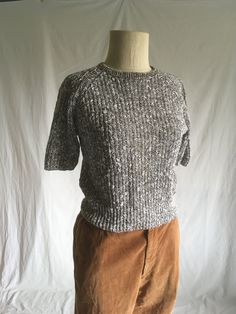 "vintage 1980s sweater Yarn Works  55% ramie, 45% cotton made in Hong Kong black/white mottled short sleeve pullover crewneck raglan cut ribbed knit  wide waist band high waist good vintage condition w/light wear/light stains on neck/on front-not very noticable-see photos labeled petite small, see below measures, lying flat, neck to sleeve-14\" chest-18\" hem-14\" length-19\"" Cotton Knit Short Sleeve Sweater, Short Sleeve Knit Sweater With Relaxed Fit, Relaxed Fit Short Sleeve Knit Sweater, Short Sleeve Cotton Sweater With Textured Knit, Cotton Textured Knit Short Sleeve Sweater, Winter Knit Sweater With Short Sleeves, Fitted Textured Knit Short Sleeve Sweater, Chunky Knit Cotton Crew Neck Top, Fitted Short Sleeve Knit Sweater