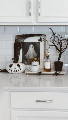 a white kitchen counter topped with halloween decorations