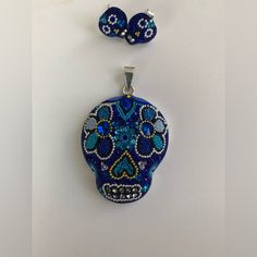 This Stunning One Of A Kind Piece Features A Meticulously Designed Sugar Skull Pendant, Adorned With Vibrant Blue Austrian Crystals And Beads. Crafted With Utmost Care And Precision, This Necklace Perfectly Blends Traditional Elegance With Contemporary Style. Made From High-Quality Silver 925, It Not Only Showcases Intricate Artistry But Also Ensures Lasting Durability. A Captivating Tribute To The Day Of The Dead Tradition, This Pendant Is A Unique Accessory That Resonates With Both Cultural Si Handmade Silver Skull Jewelry, Handmade Sterling Silver Skull Jewelry, Sugar Skull Necklace, Sugar Skull Earrings, The Day Of The Dead, Skull Necklace, Skull Pendant, Skull Earrings, Vibrant Blue