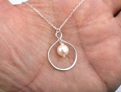 This infinity pearl necklace consists of:  1. a large asymmetric pear-shaped sterling silver infinity charm 2. a freshwater pearl (available in teardrop,coin,and round shape) hung inside the bigger lower loop of the infinity charm 3. a sterling silver chain (several lengths available) closed with a lobster clasp. 4. a personalized note card (customized with your own message, not a boiler plate one), printed on heavy weight cardstock, in elegant font and layout. ALL STERLING SILVER COMPONENTS Pac Personalized Teardrop Wedding Necklaces, Personalized Teardrop Wedding Necklace, Personalized Pearl Necklace For Wedding, Personalized Teardrop Pendant Jewelry For Wedding, Personalized Teardrop Pendant Wedding Jewelry, Personalized Teardrop Pendant For Wedding, Pear-shaped Pearl Drop Necklace As Gift, Pear-shaped Pearl Necklace Gift, Teardrop Necklace For Wedding On Mother's Day