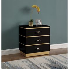 a black and gold chest of drawers in a room with a rug on the floor