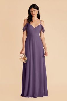 a woman wearing a purple bridesmaid dress with an open shoulder and spaghetti straps