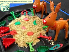 there are plastic toys in the shape of reindeers and snowflakes on a tray