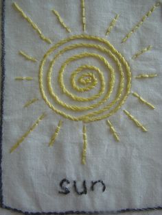 the sun has been embroidered onto this piece of cloth