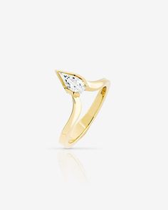 a yellow gold ring with a white diamond in the center and an arrow shaped band