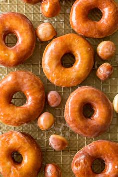 several glazed donuts on a cooling rack