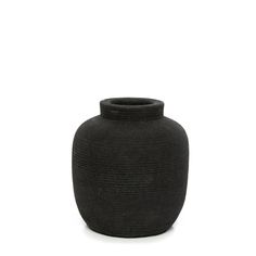 a black vase sitting on top of a white surface