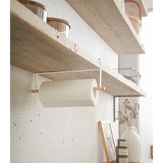 some shelves with toilet paper and cups on them