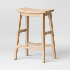 a wooden stool on a white background with no one around it or the seat up