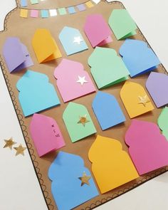 a paper board with cut out shapes and stars on it, sitting on a table