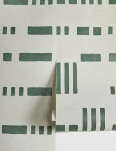 two pieces of paper with green and white lines on them, next to each other